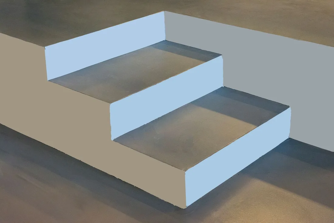 Close-up of smooth concrete stair treads and painted risers; illustrative stock photo