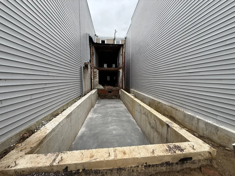 Poured foundation walls and slab at the same Golden Brick rear addition