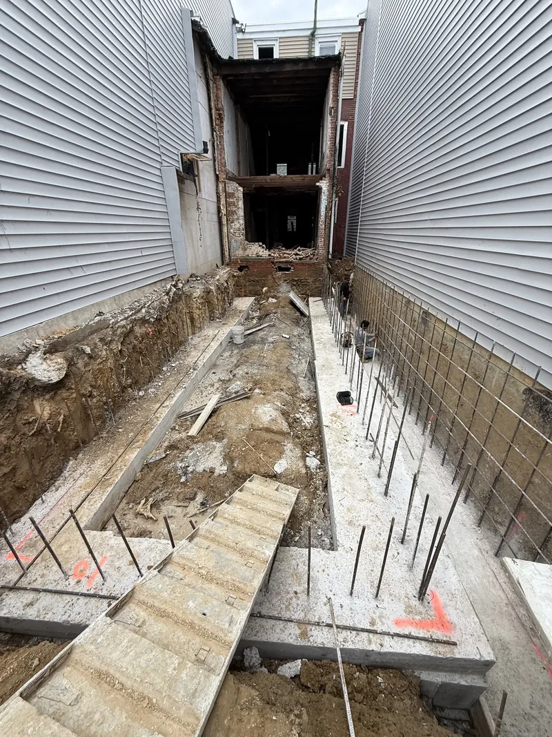Foundation excavation and reinforcement at a Golden Brick rear addition