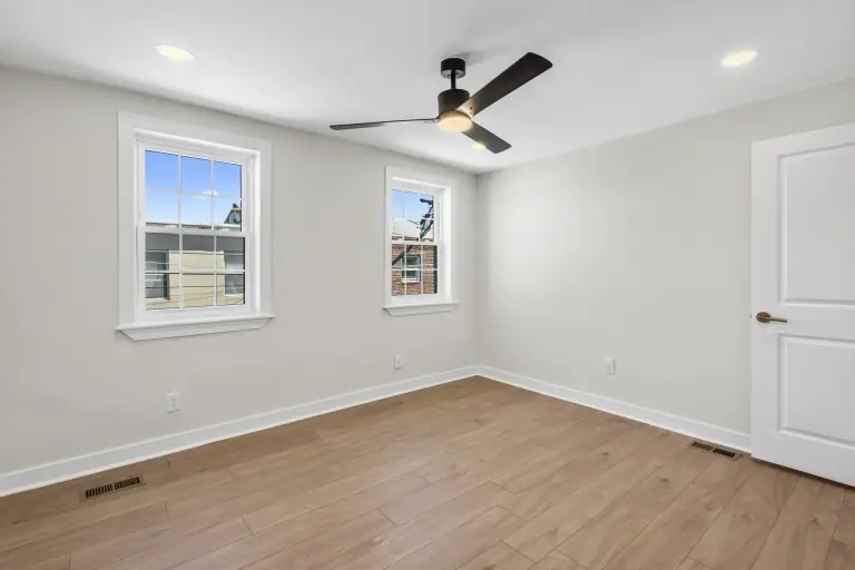 Finished bedroom after flooring, paint, trim, lighting, and cleanup
